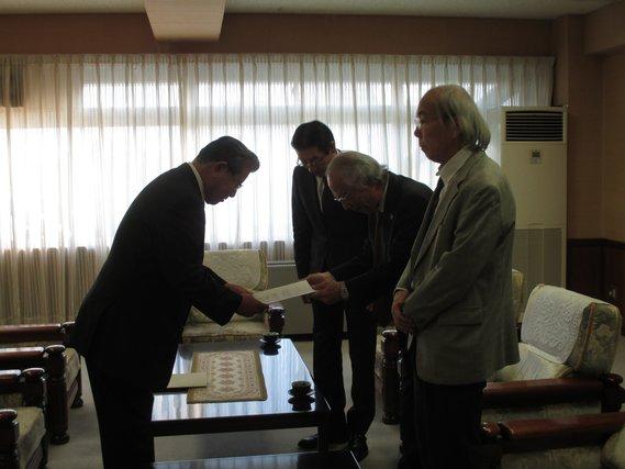公職選挙法における住所要件の適正運用等に関する検証委員会より作成された、住所要件の意見書が手渡される様子の写真