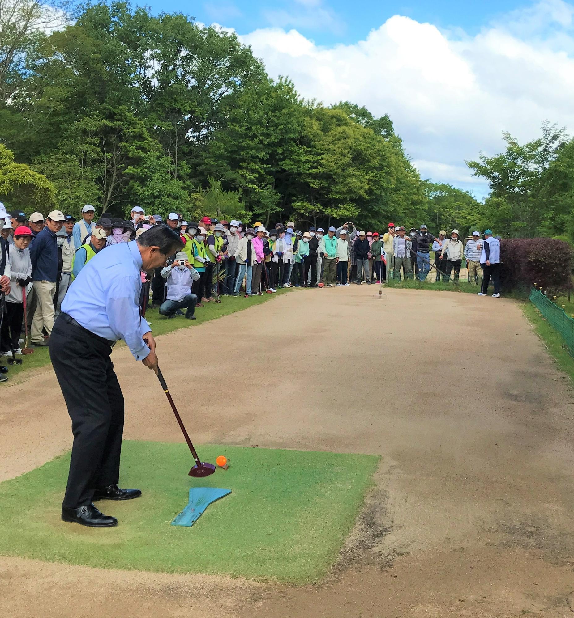 市長杯グラウンドゴルフ大会で市長が始球式を行う様子の写真