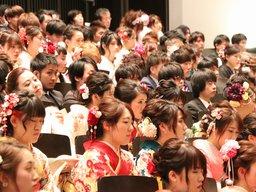 新成人達が席に座ってスクリーンを眺める写真