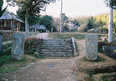 石の階段を挟むように建つ地蔵石仏の写真