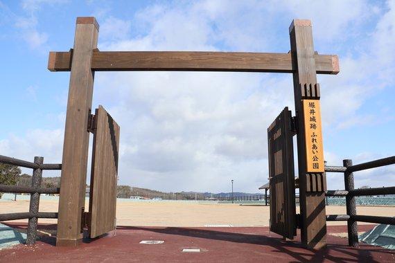 「堀井城跡ふれあい公園」という札がかかっている冠木門の写真