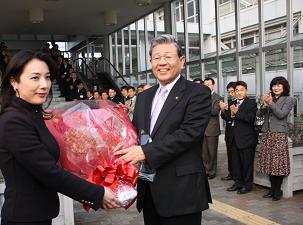 女性から大きな花束を受け取っている市長の写真