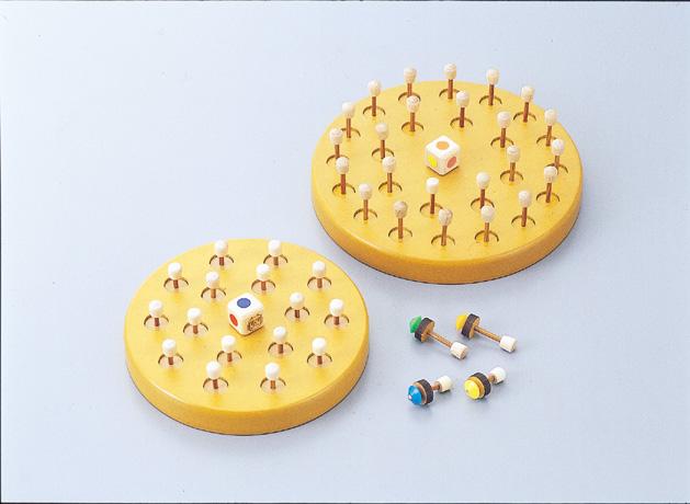 黄色い丸い円状の中心に小さなサイコロが装着され、そのまわりを小さな棒が囲うように装着されている様子のロバンゲームの写真